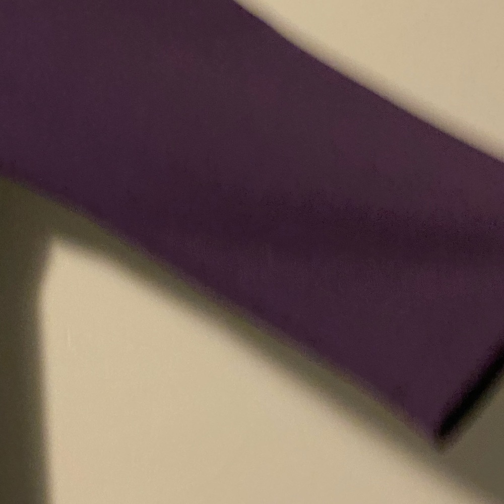 Purple three quarter sleeve dress that is right above ankle.